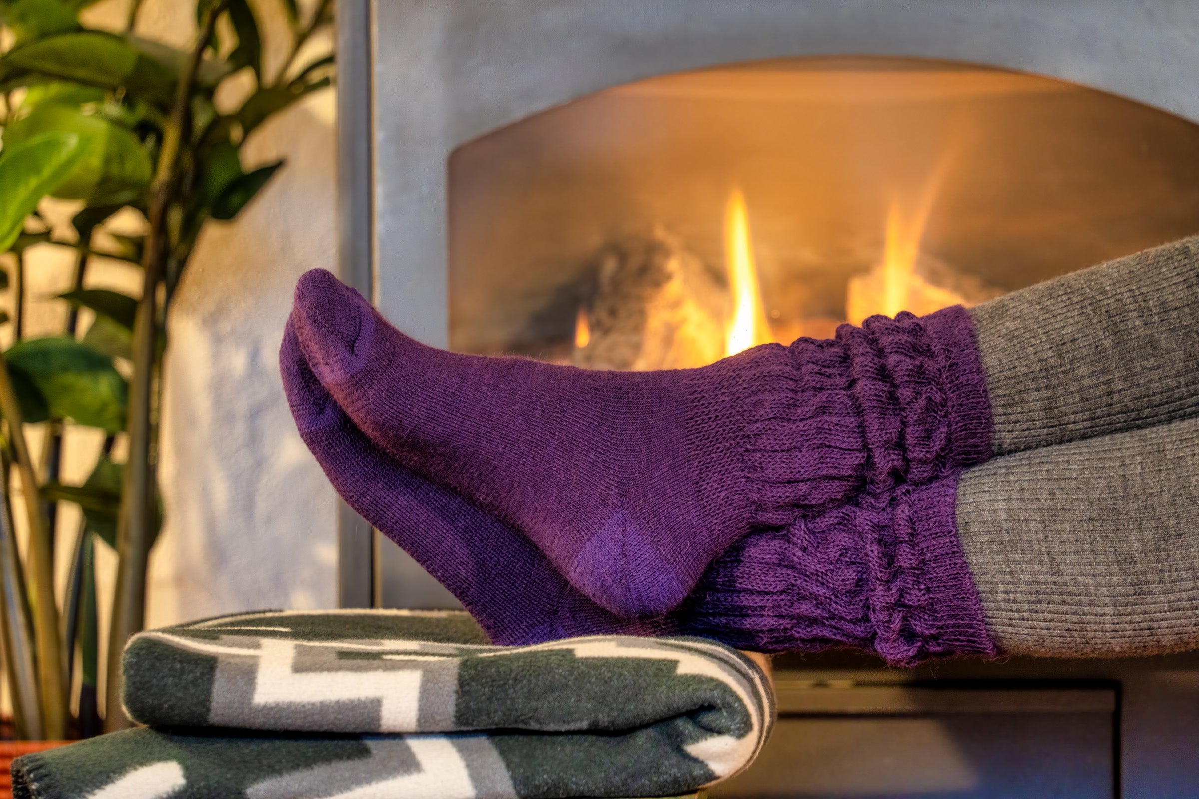 ABD Therapeutic Alpaca Socks Collection - Purple Alpaca Socks Worn By Someone in front of a fireplace